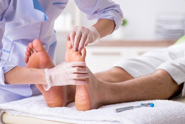 Podiatrist treating feet during procedure